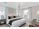 Cozy bedroom featuring large windows, comfortable bed, stylish lighting, and tasteful decor at 16354 Grey Pine Dr, Winter Garden, FL 34787