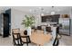 Dining area adjoining the modern kitchen with stainless steel appliances and white countertops at 16354 Grey Pine Dr, Winter Garden, FL 34787