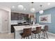 Modern kitchen with stainless steel appliances, a center island, and stylish pendant lighting at 16354 Grey Pine Dr, Winter Garden, FL 34787