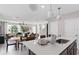 Bright kitchen with a large island, quartz countertops, and open concept to the living room and dining area at 16354 Grey Pine Dr, Winter Garden, FL 34787