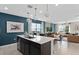 Modern kitchen with a large island, stainless steel appliances, and open concept to the living room at 16354 Grey Pine Dr, Winter Garden, FL 34787