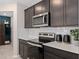 Well-equipped kitchen featuring stainless steel appliances, ample counter space, and sleek cabinetry at 16354 Grey Pine Dr, Winter Garden, FL 34787