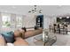 Spacious living area flows into the dining and kitchen, featuring modern furniture and decor at 16354 Grey Pine Dr, Winter Garden, FL 34787