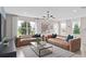 Bright living room features contemporary decor, stylish furniture, and large windows at 16354 Grey Pine Dr, Winter Garden, FL 34787