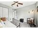 Bedroom with neutral walls featuring carpeted floors, ceiling fan and view to the closet at 1986 Yellowfin Dr, Port Orange, FL 32128