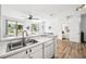 Modern kitchen with stainless steel sink, tile backsplash, and view to living room at 1986 Yellowfin Dr, Port Orange, FL 32128