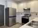 Updated kitchen features stainless steel appliances, white cabinets, and light countertops at 1986 Yellowfin Dr, Port Orange, FL 32128