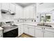 Bright kitchen with stainless steel appliances and white cabinetry at 1986 Yellowfin Dr, Port Orange, FL 32128
