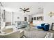 Bright living room with modern furniture, ceiling fan, and stylish decor throughout open floor plan at 1986 Yellowfin Dr, Port Orange, FL 32128