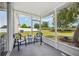 Screened patio with two chairs perfect for outdoor enjoyment and views of the backyard at 1986 Yellowfin Dr, Port Orange, FL 32128