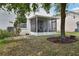 Cozy screened patio with outdoor seating and well maintained landscaping offers relaxation and privacy at 1986 Yellowfin Dr, Port Orange, FL 32128