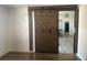 Rustic sliding barn door for bedroom privacy, showing off modern wood laminate flooring at 2236 Dancy Trail Trl, Clermont, FL 34714