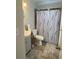 Bathroom featuring a vanity, toilet, patterned shower curtain and gray rug at 2236 Dancy Trail Trl, Clermont, FL 34714