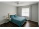 This bedroom features wood floors, a ceiling fan, a window, and minimalist decor at 2236 Dancy Trail Trl, Clermont, FL 34714