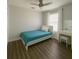 This bedroom features wood floors, a ceiling fan, a window, and a white vanity at 2236 Dancy Trail Trl, Clermont, FL 34714