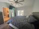 This bedroom features wood floors, a ceiling fan, a TV, and a sliding door to a pool and patio area at 2236 Dancy Trail Trl, Clermont, FL 34714
