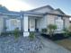 Charming single-story home with decorative rock landscaping, garden bed, and welcoming front entryway at 2236 Dancy Trail Trl, Clermont, FL 34714
