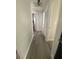 Hallway with wood floors connecting rooms with neutral walls and ample lighting at 2236 Dancy Trail Trl, Clermont, FL 34714