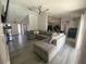 Spacious living room featuring a ceiling fan, open layout, and stylish gray laminate flooring at 2236 Dancy Trail Trl, Clermont, FL 34714