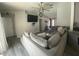 Comfortable living space features a sectional sofa, ceiling fan, and an open floor plan at 2236 Dancy Trail Trl, Clermont, FL 34714