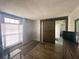 Cozy living room showcasing wood laminate floors, barn door, and a bright window with blinds at 2236 Dancy Trail Trl, Clermont, FL 34714