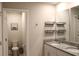 Bathroom with granite countertop, double sinks, modern fixtures, toilet, and tiled floor at 2415 Sweet Viburnum Way, Ocoee, FL 34761