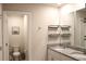 Bathroom with granite countertop, double sinks, modern fixtures, toilet, and tiled floor at 2415 Sweet Viburnum Way, Ocoee, FL 34761