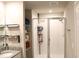 Bathroom featuring a granite countertop, sink, stylish fixtures, shelving, and glass-enclosed shower at 2415 Sweet Viburnum Way, Ocoee, FL 34761