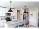 Modern kitchen with granite countertops, stainless steel appliances, island with seating, and pendant lighting at 2415 Sweet Viburnum Way, Ocoee, FL 34761