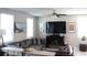 Inviting living room featuring a comfortable leather sectional, a ceiling fan, and bright natural light at 2415 Sweet Viburnum Way, Ocoee, FL 34761