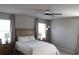 Bright main bedroom featuring neutral tones, a ceiling fan, and bedside tables with lamps at 2415 Sweet Viburnum Way, Ocoee, FL 34761
