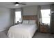 Bright main bedroom featuring neutral tones, a ceiling fan, and bedside tables with lamps at 2415 Sweet Viburnum Way, Ocoee, FL 34761