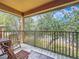 Outdoor balcony with seating and view of the surrounding trees at 2744 Calabria Ave, Davenport, FL 33897