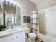 This standard bathroom offers a shower-tub combination, vanity, and linen storage at 2744 Calabria Ave, Davenport, FL 33897
