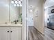 Bathroom with a light beige vanity and a glimpse into the hallway and kitchen at 2744 Calabria Ave, Davenport, FL 33897