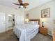 This cozy bedroom offers a ceiling fan, side tables with lamps, and adjoining bath and closet at 2744 Calabria Ave, Davenport, FL 33897