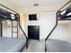 Bedroom with two bunk beds, dresser, and television for comfortable living at 2744 Calabria Ave, Davenport, FL 33897