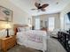 Bright bedroom features a ceiling fan, cozy décor, and natural light from two windows at 2744 Calabria Ave, Davenport, FL 33897