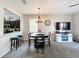 Dining area featuring a four chair table, pendant lighting, and view into kitchen at 2744 Calabria Ave, Davenport, FL 33897