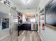 Bright kitchen with stainless steel appliances, and view to the living area and decorative elements at 2744 Calabria Ave, Davenport, FL 33897