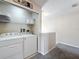 Efficient laundry area featuring a washer, dryer, and open shelving for storage at 2744 Calabria Ave, Davenport, FL 33897