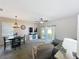 Comfortable living room with ceiling fan, TV, dining table, and sliding glass doors to an outdoor patio at 2744 Calabria Ave, Davenport, FL 33897