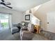 Comfortable living room featuring a grey sectional, recliner, and view of staircase at 2744 Calabria Ave, Davenport, FL 33897