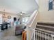 Open-plan living space with a dining area, cozy seating, and staircase with -safety gate at 2744 Calabria Ave, Davenport, FL 33897