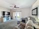Relaxing living room with a large TV, comfortable seating, and access to an outdoor patio at 2744 Calabria Ave, Davenport, FL 33897