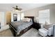 Cozy main bedroom with plush carpeting, a ceiling fan, and an adjacent walk-in closet at 2744 Calabria Ave, Davenport, FL 33897