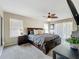 Main bedroom with a ceiling fan, windows with blinds, and access to the exterior patio at 2744 Calabria Ave, Davenport, FL 33897