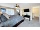 Spacious main bedroom with a ceiling fan, balcony access and a TV at 2744 Calabria Ave, Davenport, FL 33897