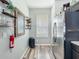 Pantry area with wood-look flooring, storage shelves, stainless refrigerator, and natural light at 2744 Calabria Ave, Davenport, FL 33897