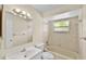 Clean bathroom featuring a tub with shower, modern vanity, and tiled walls at 288 Howard Blvd, Longwood, FL 32750